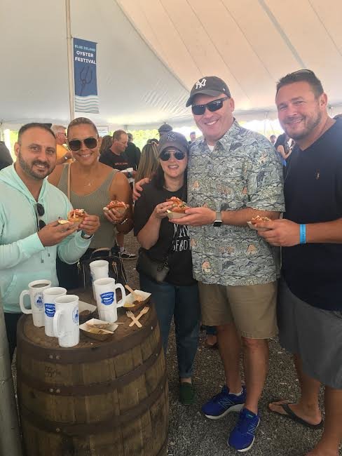 A very happy group from Sayville indulging in the plentiful array of foods including lobster rolls, plus beer, wine, iced tea or lemonade served in souvenir Blue Island Oyster Company mugs.